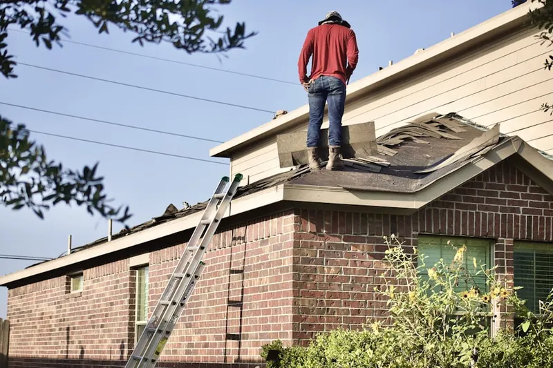 Professional roofer working on a residential roof in Five Oaks
